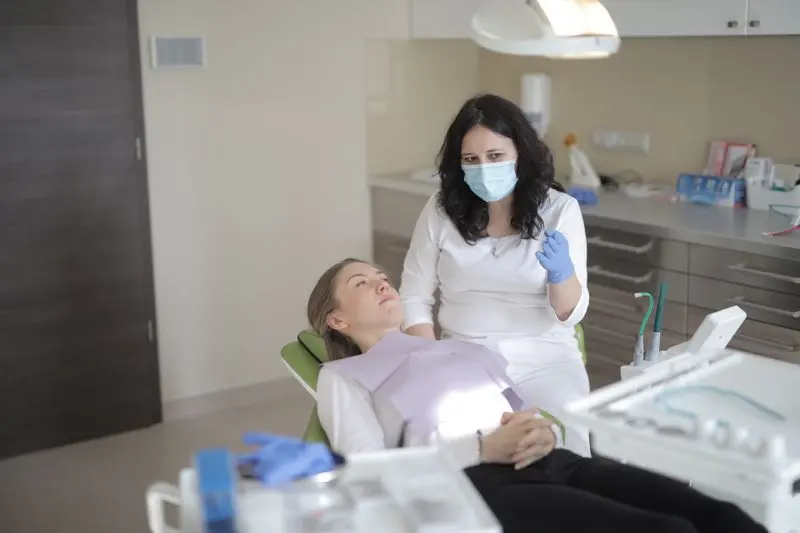 Dentist discussing care with a patient in a clinic